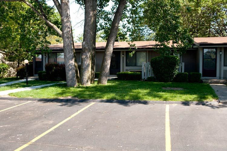 A house with a parking lot in front of it