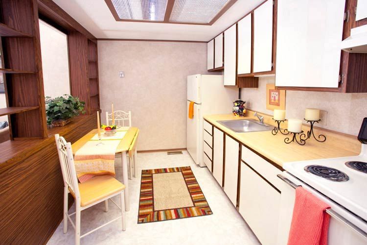 A kitchen with a table and chairs and a refrigerator