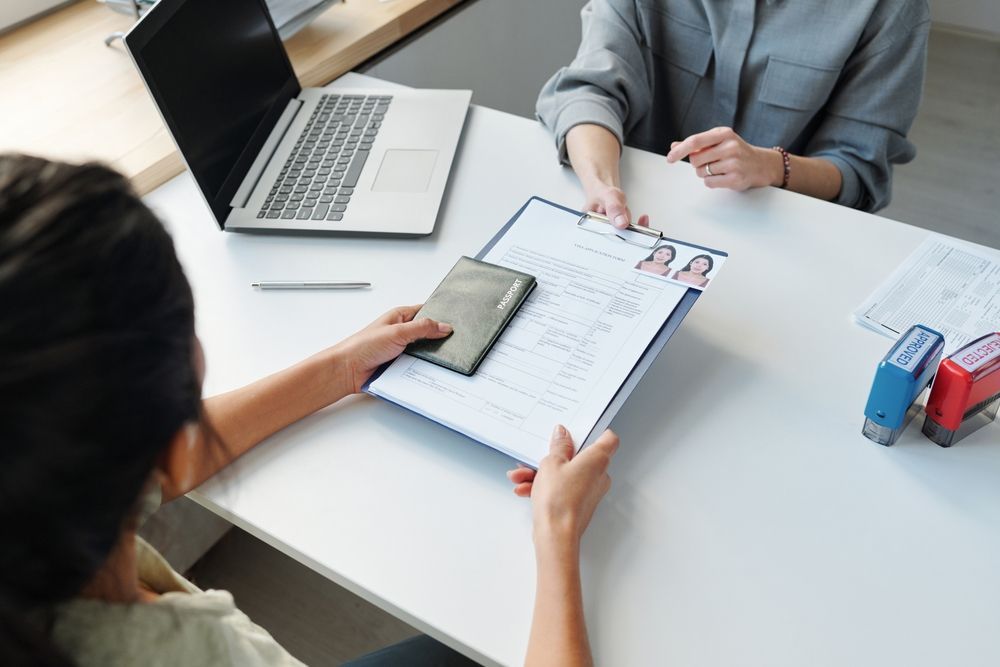 Two women are sitting at a table having a job interview.