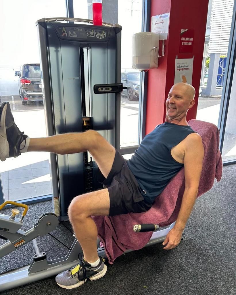 A Man is Sitting on a Machine in a Gym β Health First Townsville In Townsville, QLD