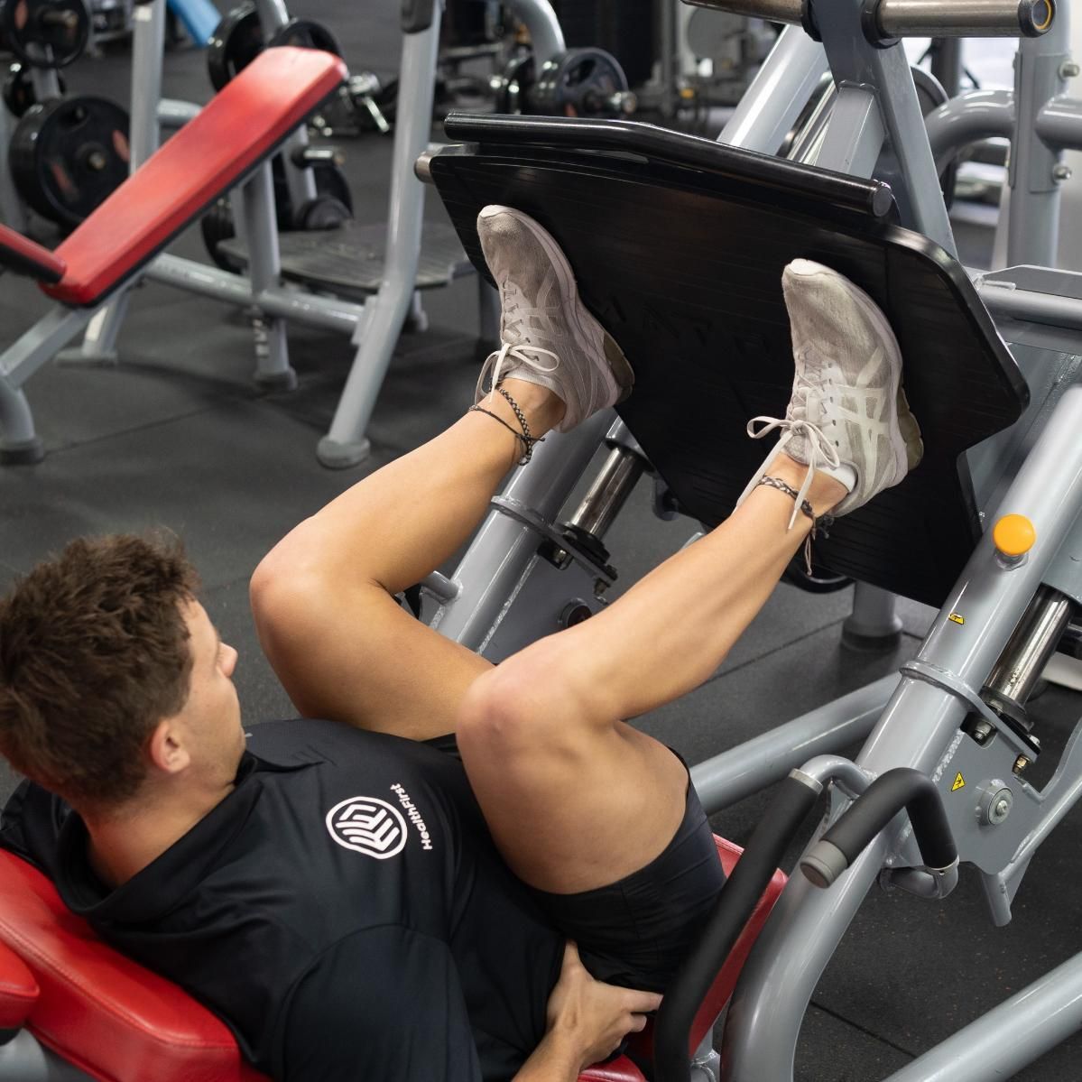 A Man is Using a Leg Press Machine in a Gym β Health First Townsville In Townsville, QLD