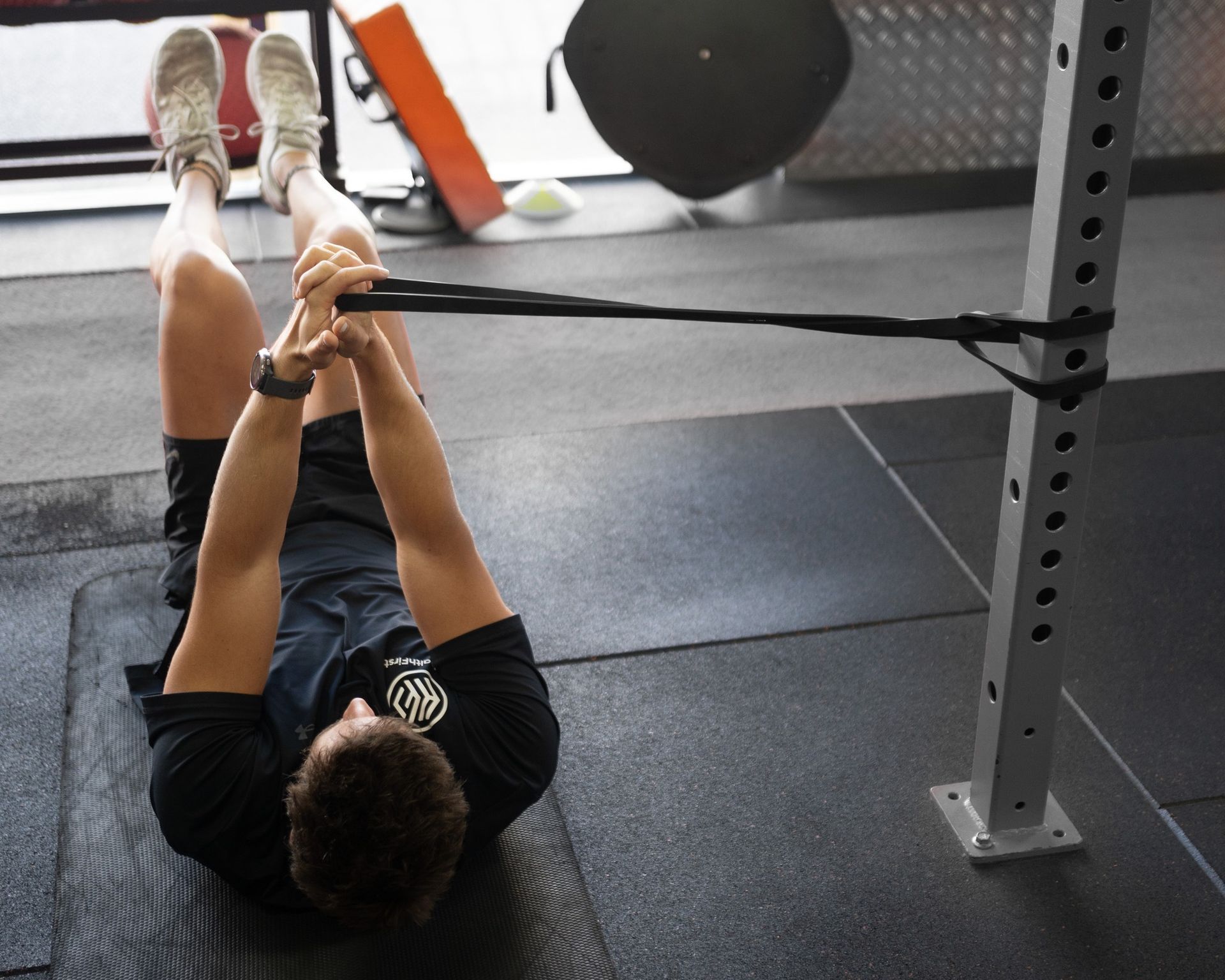 A Man is Laying on the Floor With His Legs Crossed β Health First Townsville In Townsville, QLD