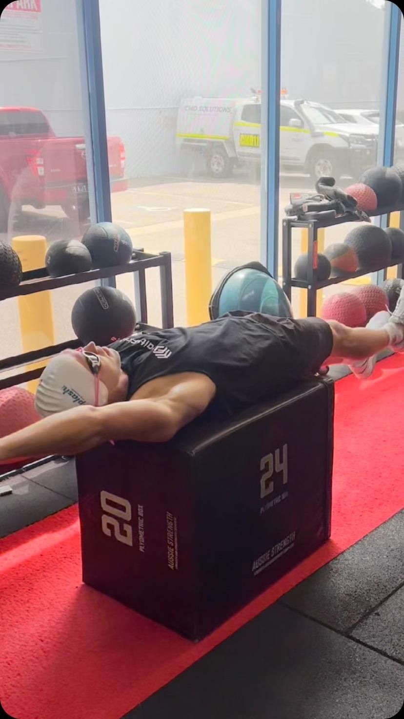 A Man is Laying on a Box in a Gym — Health First Townsville In Townsville, QLD