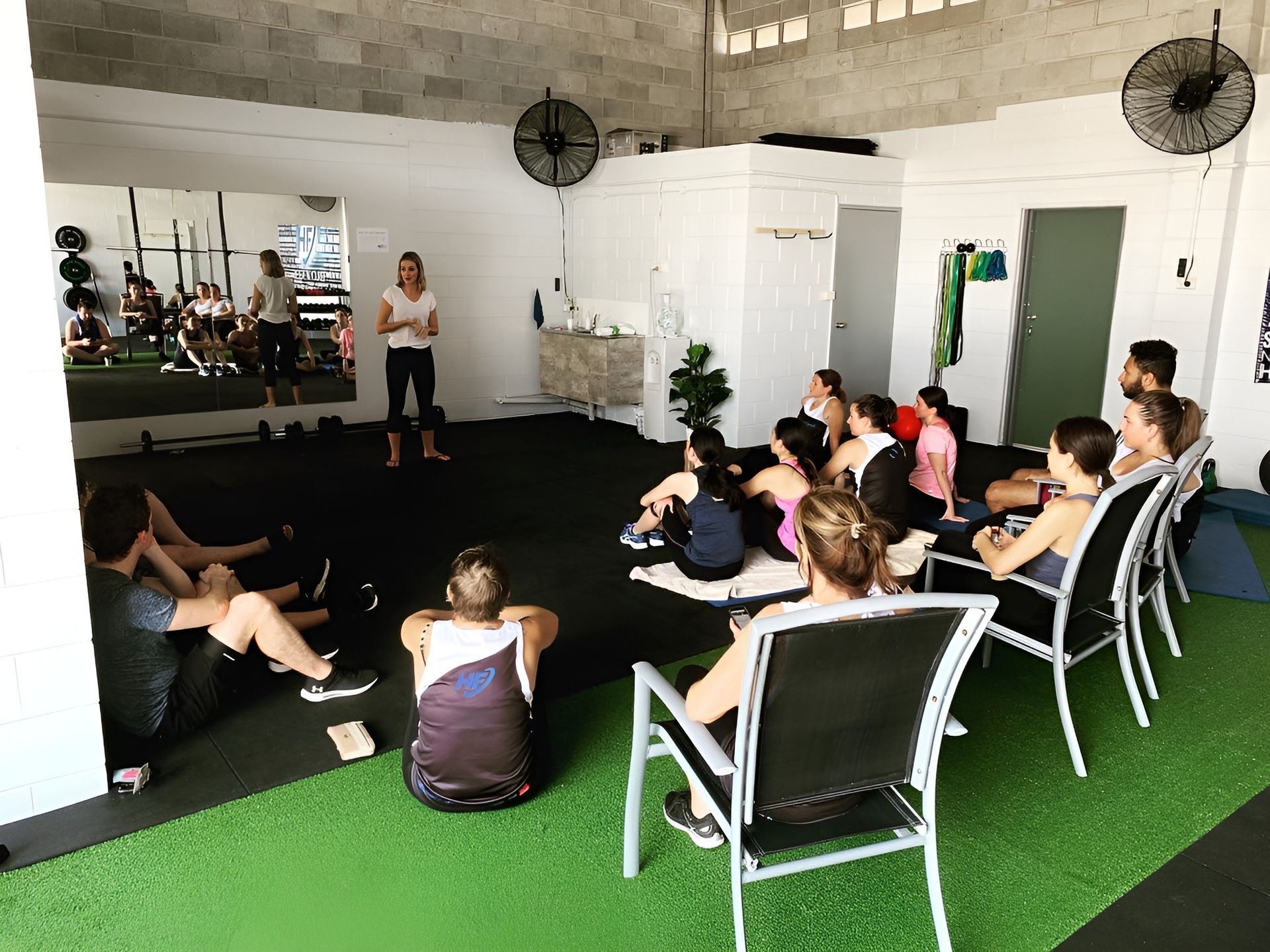 A Group of People Are Sitting in Chairs in a Gym — Health First Townsville In Townsville, QLD