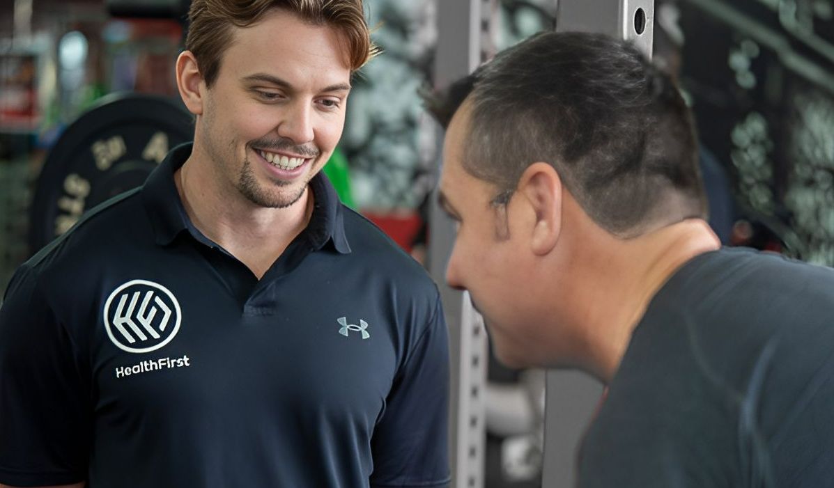 Two Men Are Talking to Each Other in a Gym β Health First Townsville In Townsville, QLD