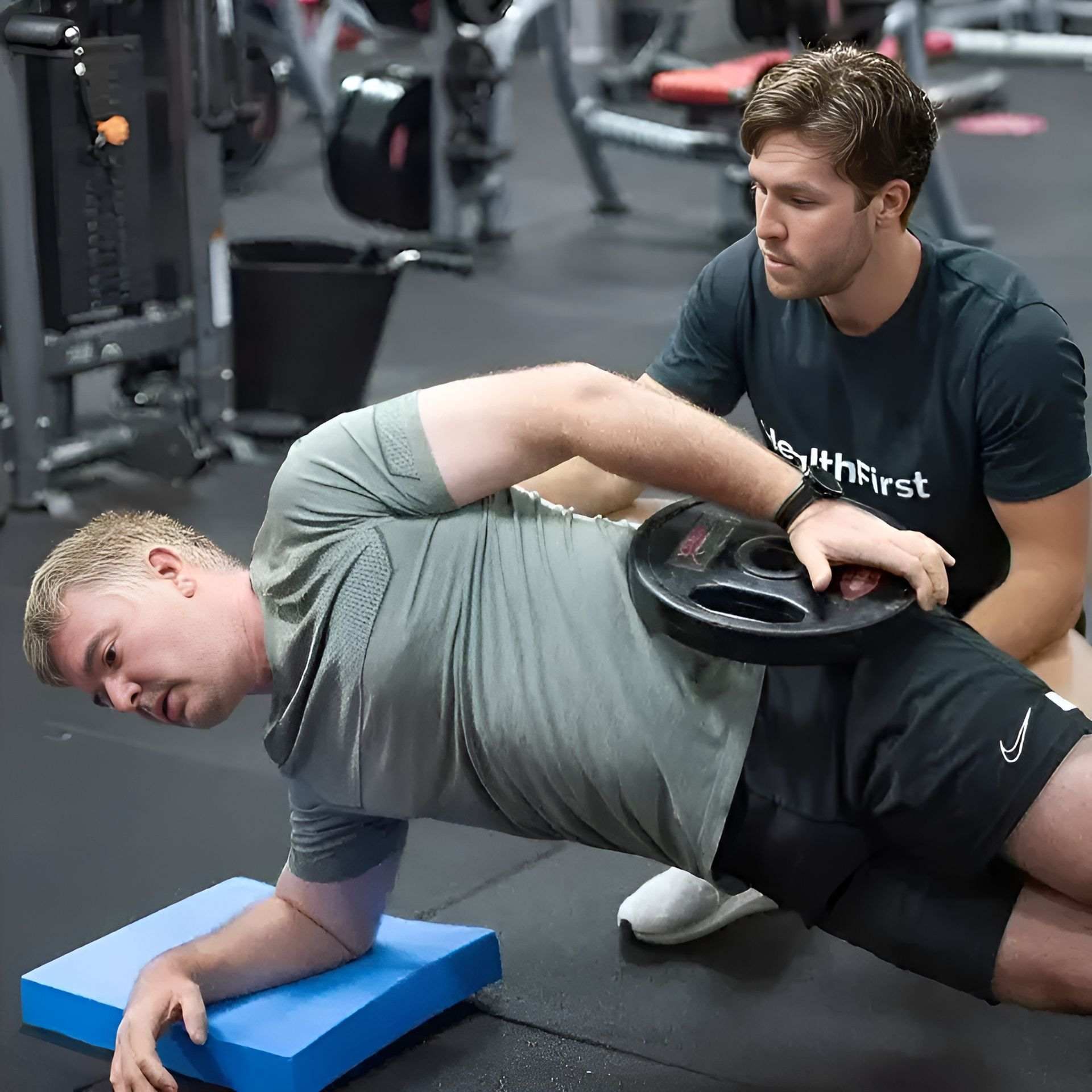 A Man in a Black Shirt With the Word First on It is Helping Another Man β Health First Townsville In Townsville, QLD