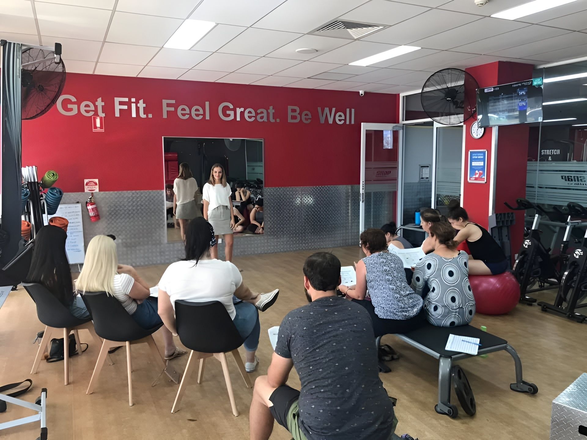 A Group of People Are Sitting Around a Table in a Gym — Health First Townsville In Aitkenvale, QLD