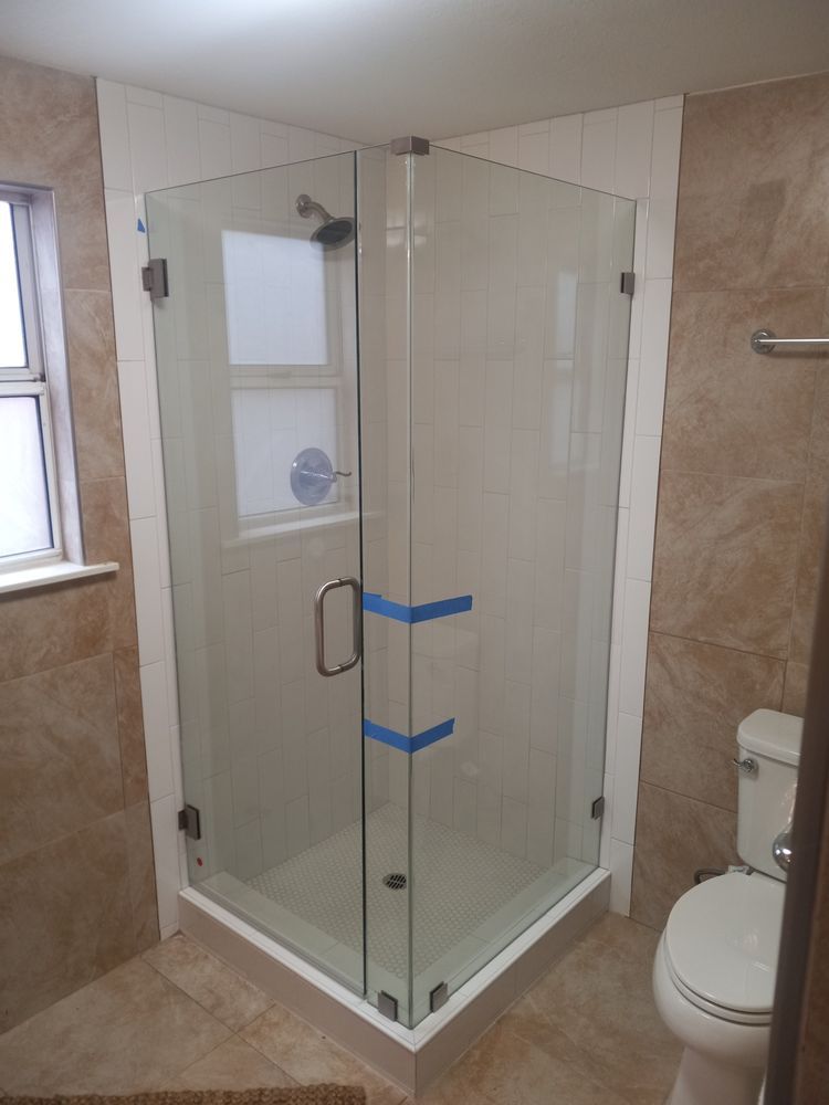 A bathroom with a shower stall and a toilet.