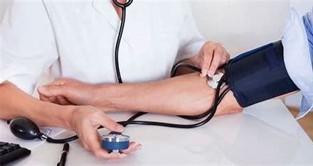 A woman takes a man's blood pressure — AMC Exercise Physiology in Maitland, NSW