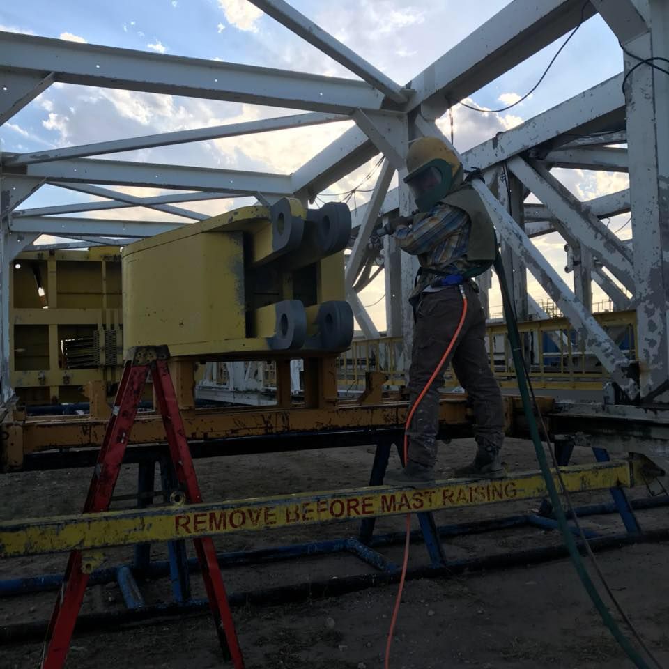 a man standing on a ladder next to a sign that says remove before mast keeping