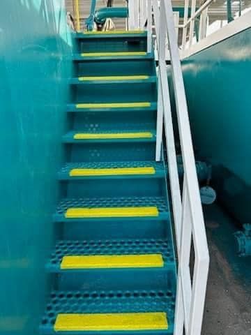 a set of blue stairs with yellow steps and a white railing .