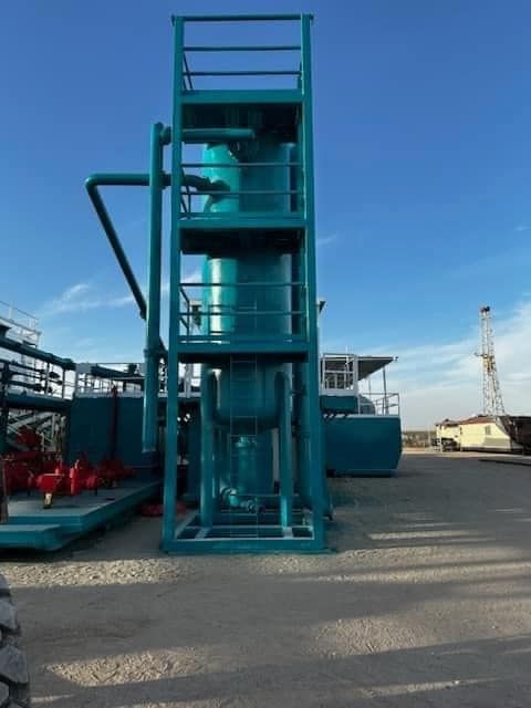 a large green tower with stairs and a blue sky in the background