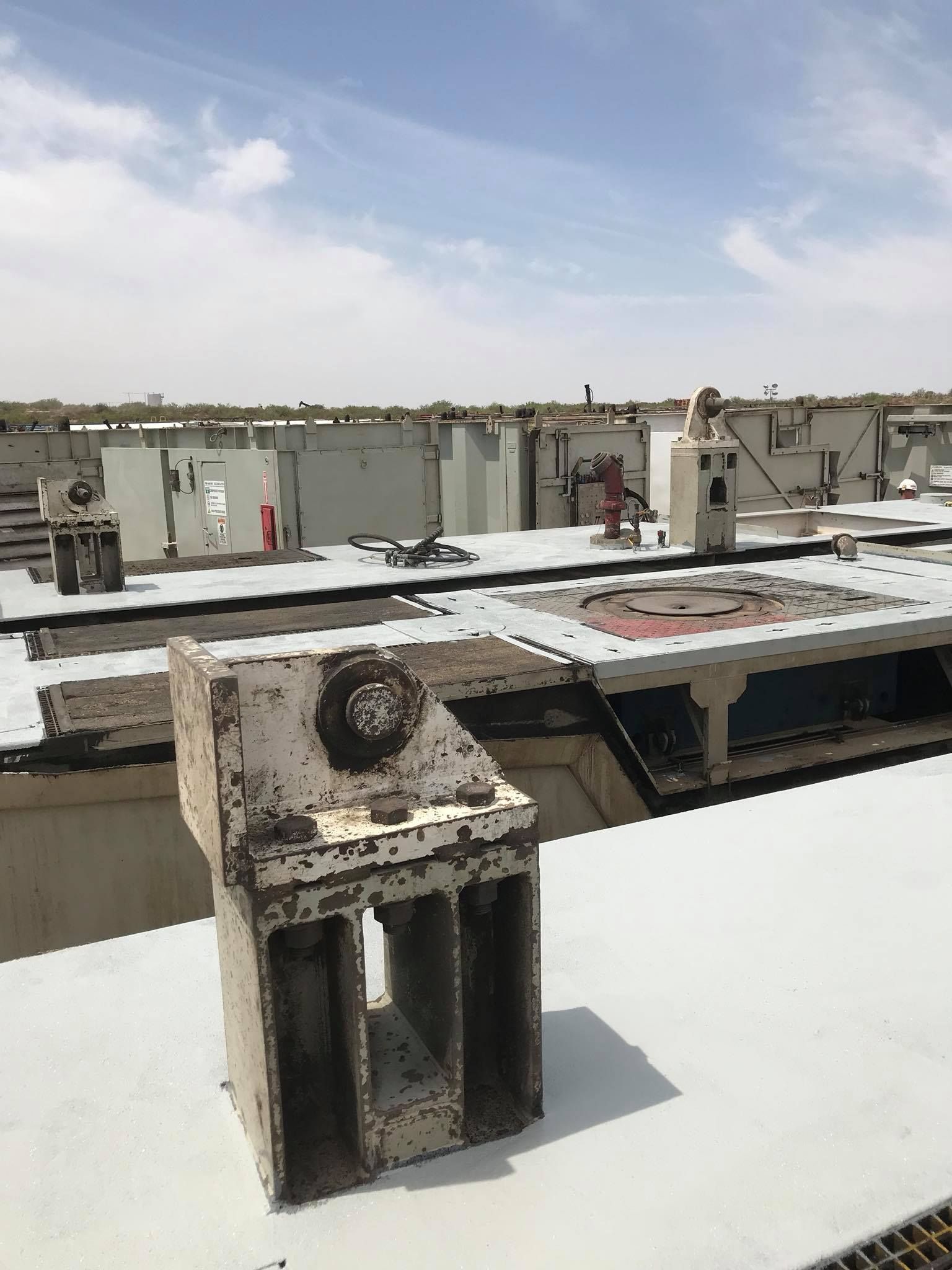 a piece of metal is sitting on top of a building .
