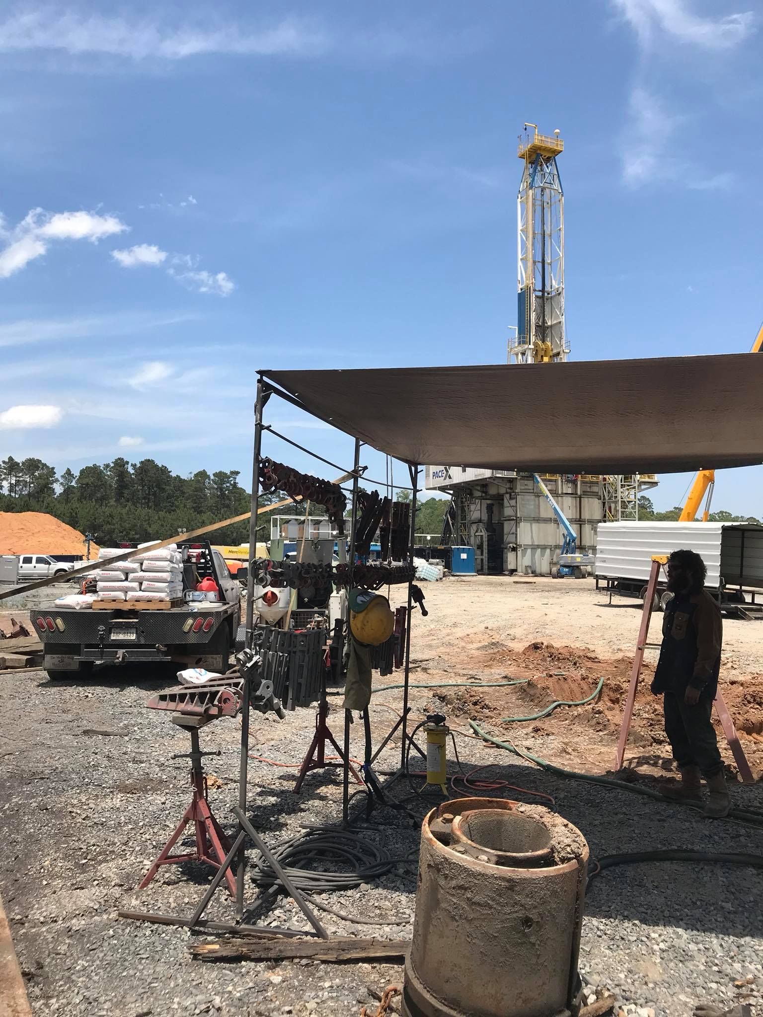 a man is standing under a canopy in a construction site .