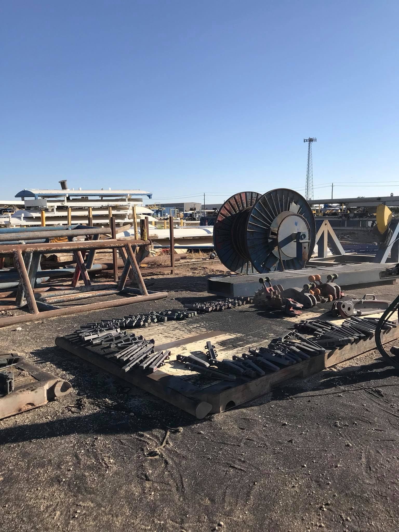a large spool of wire is sitting on top of a wooden pallet .