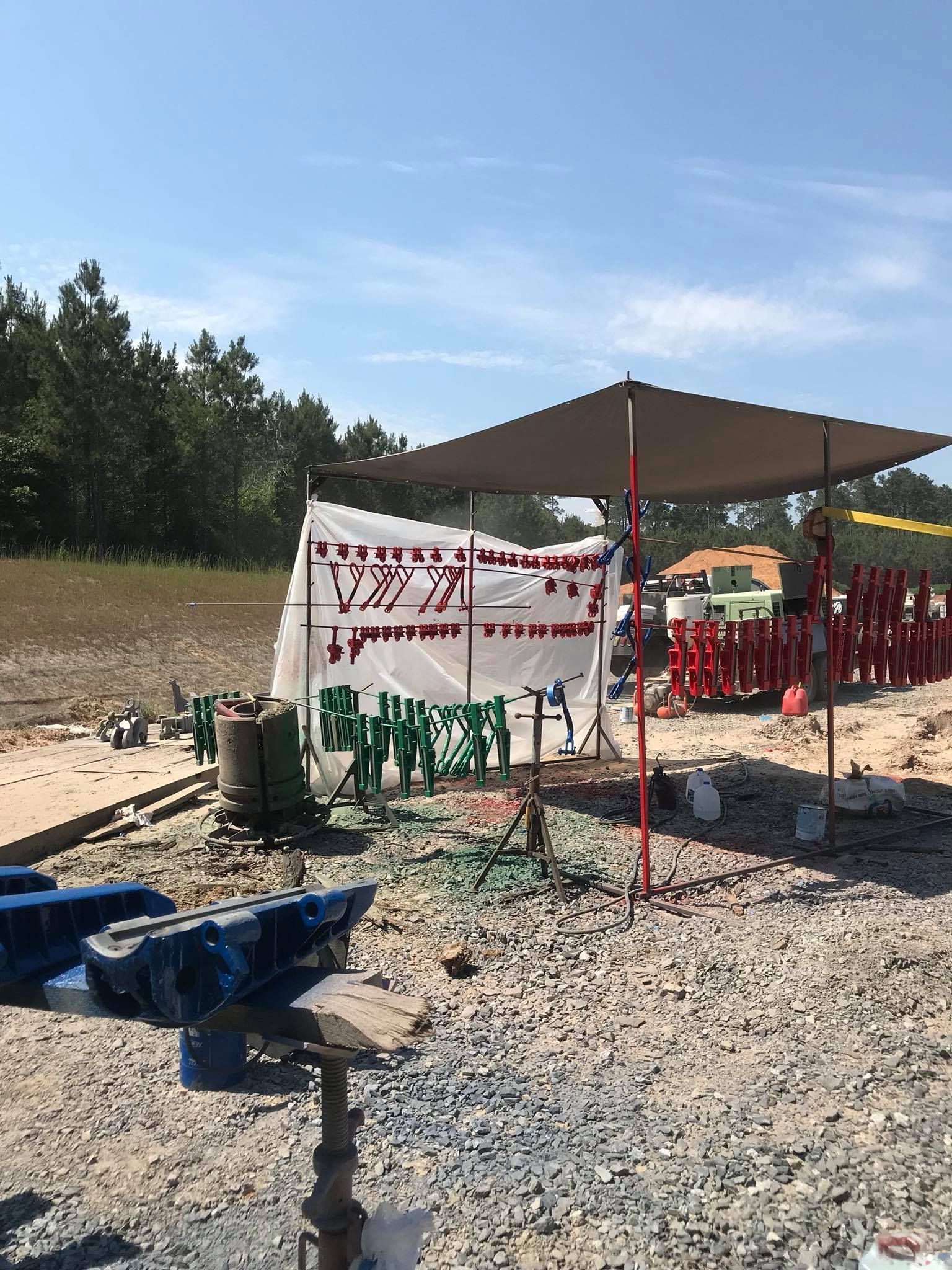 a tent is sitting in the middle of a dirt field .