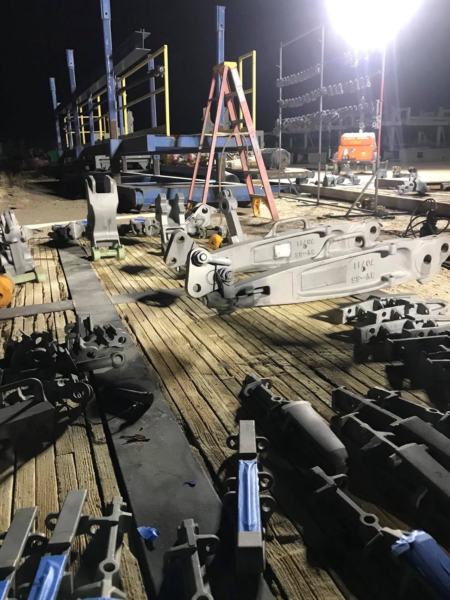 a lot of machinery is sitting on a wooden deck at night