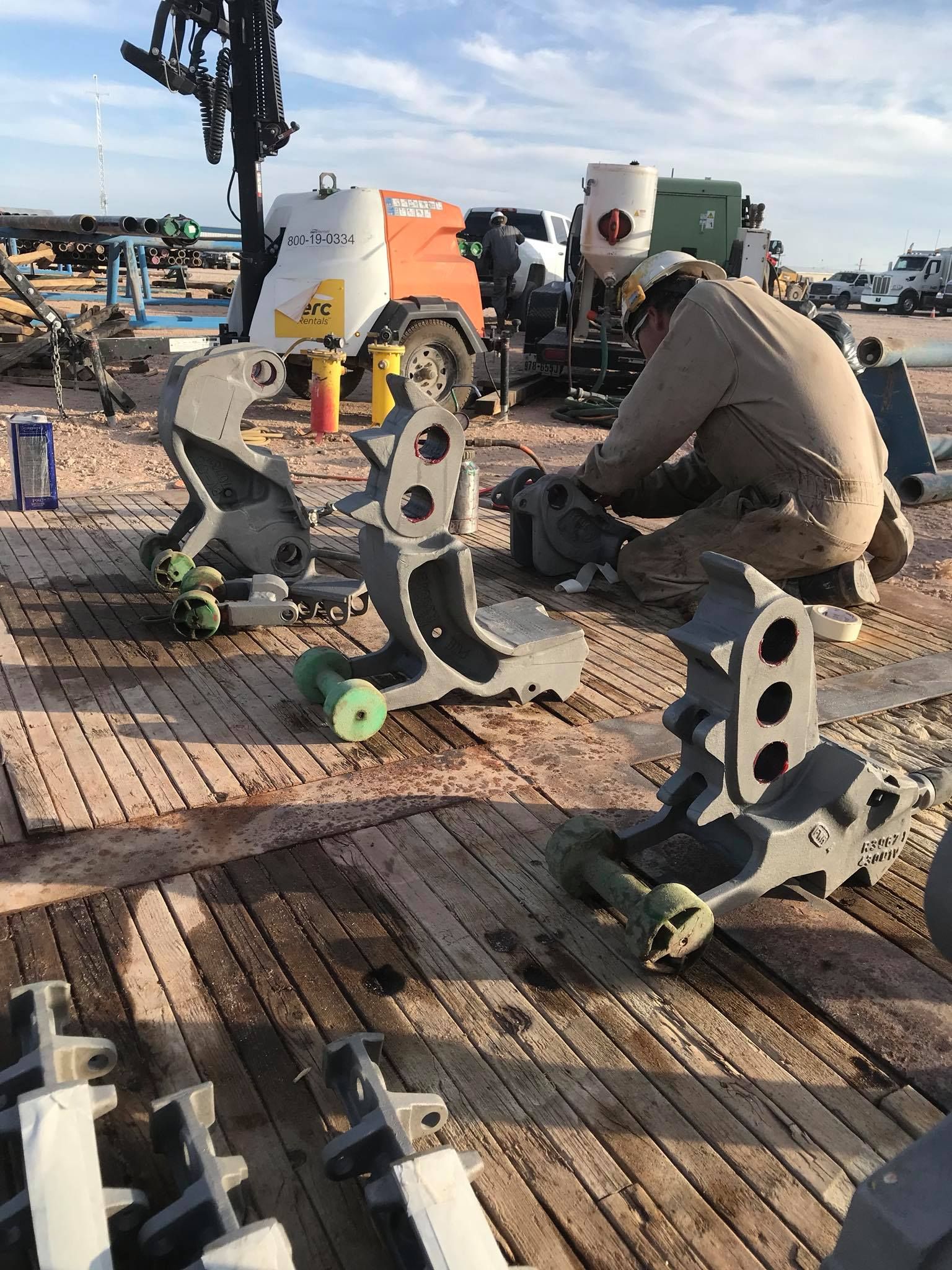 a man is working on a piece of equipment on a wooden deck .