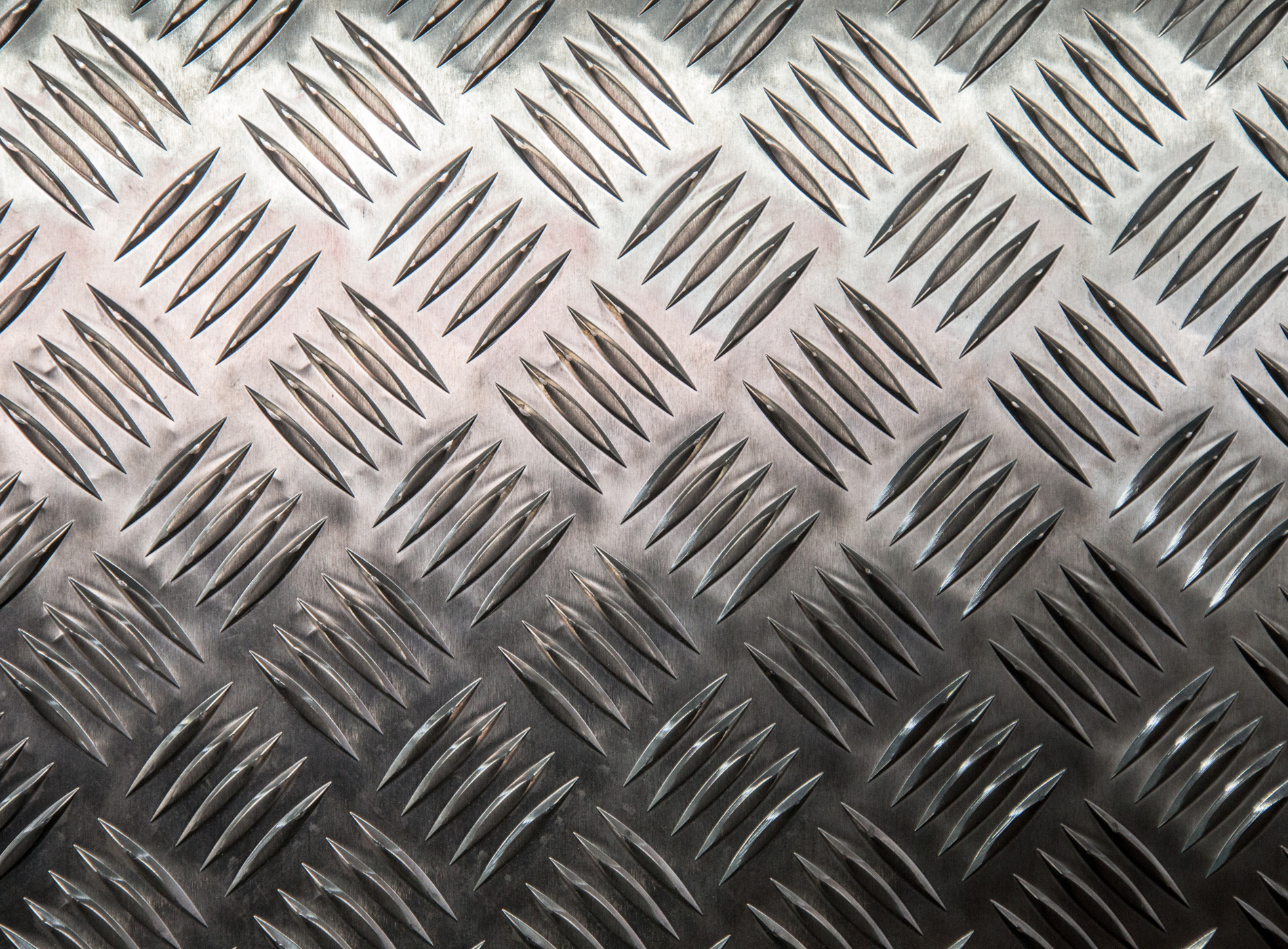 a close up of a metal surface with a checkered pattern .