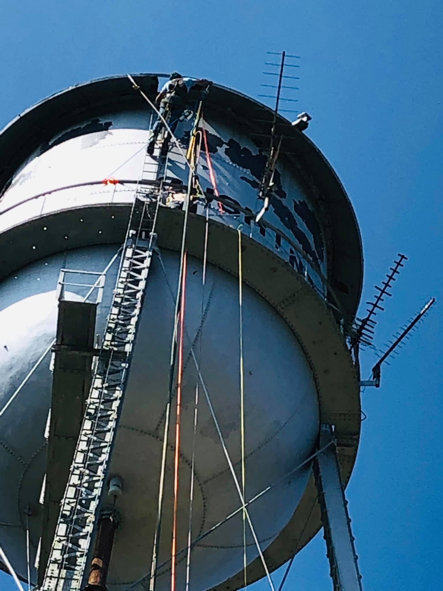 a water tower with a blue sky in the background