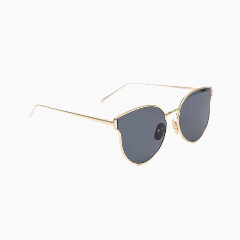 A pair of sunglasses with a gold frame and black lenses