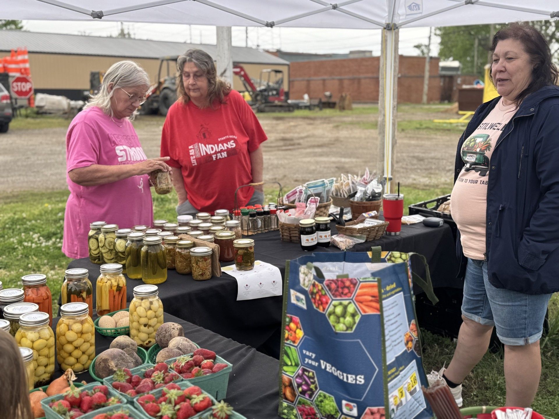 Tina Rose, Farmers Market manager, right, chats with Beth Fatherree and Eugene Liver.