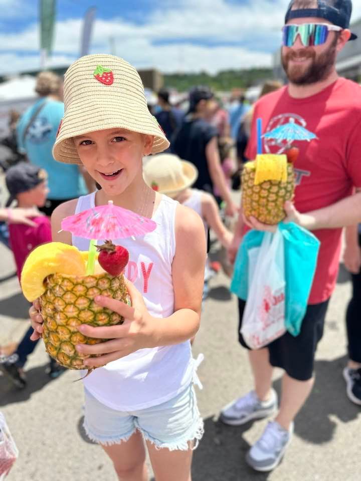 Brielle Winters, age 9, and Malachi Kocher were enjoying pineapple whip in fresh pineapples at the 2025 festival.