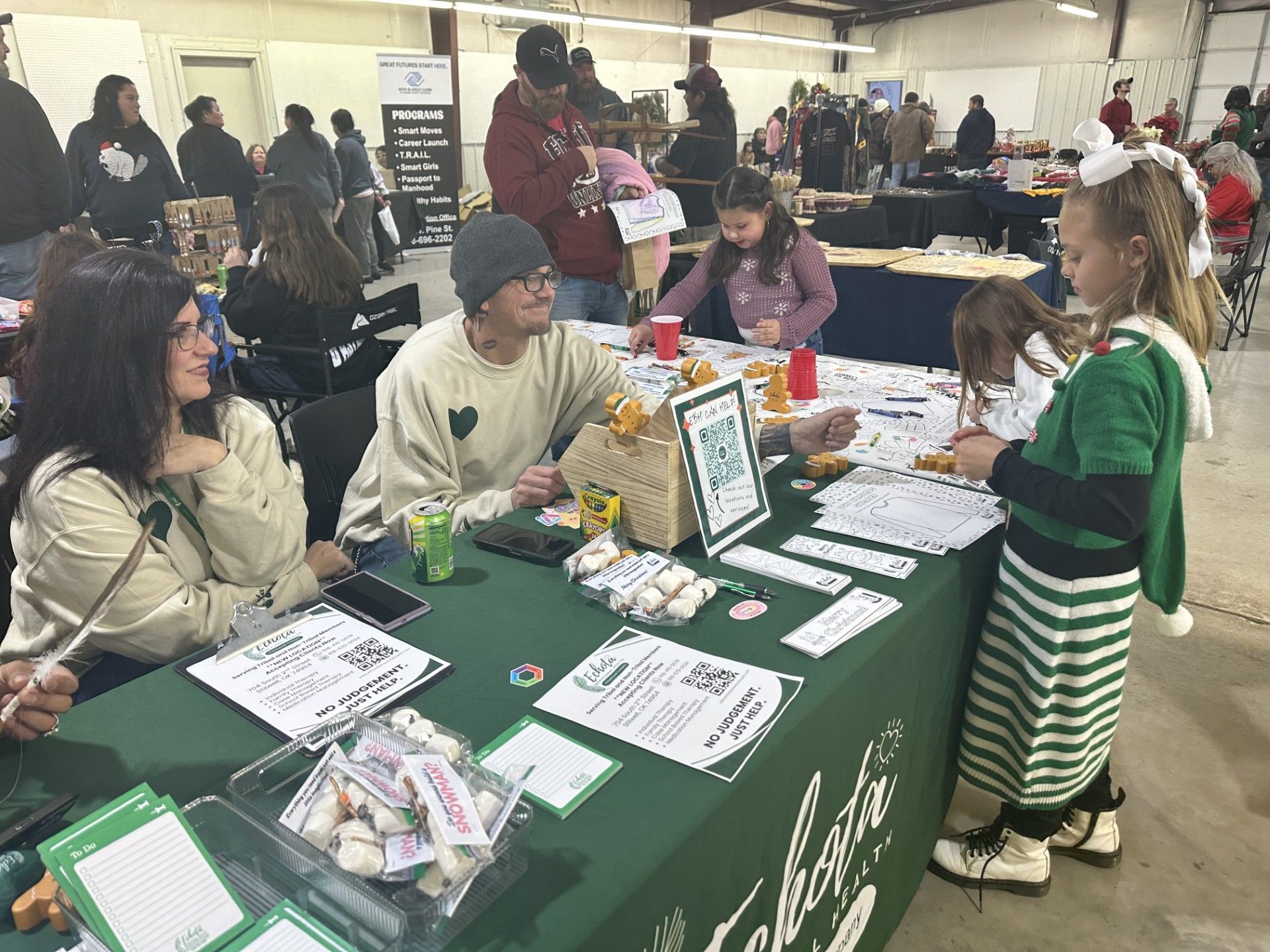 Two girls make art to take with them at the Echota Behavioral Health booth