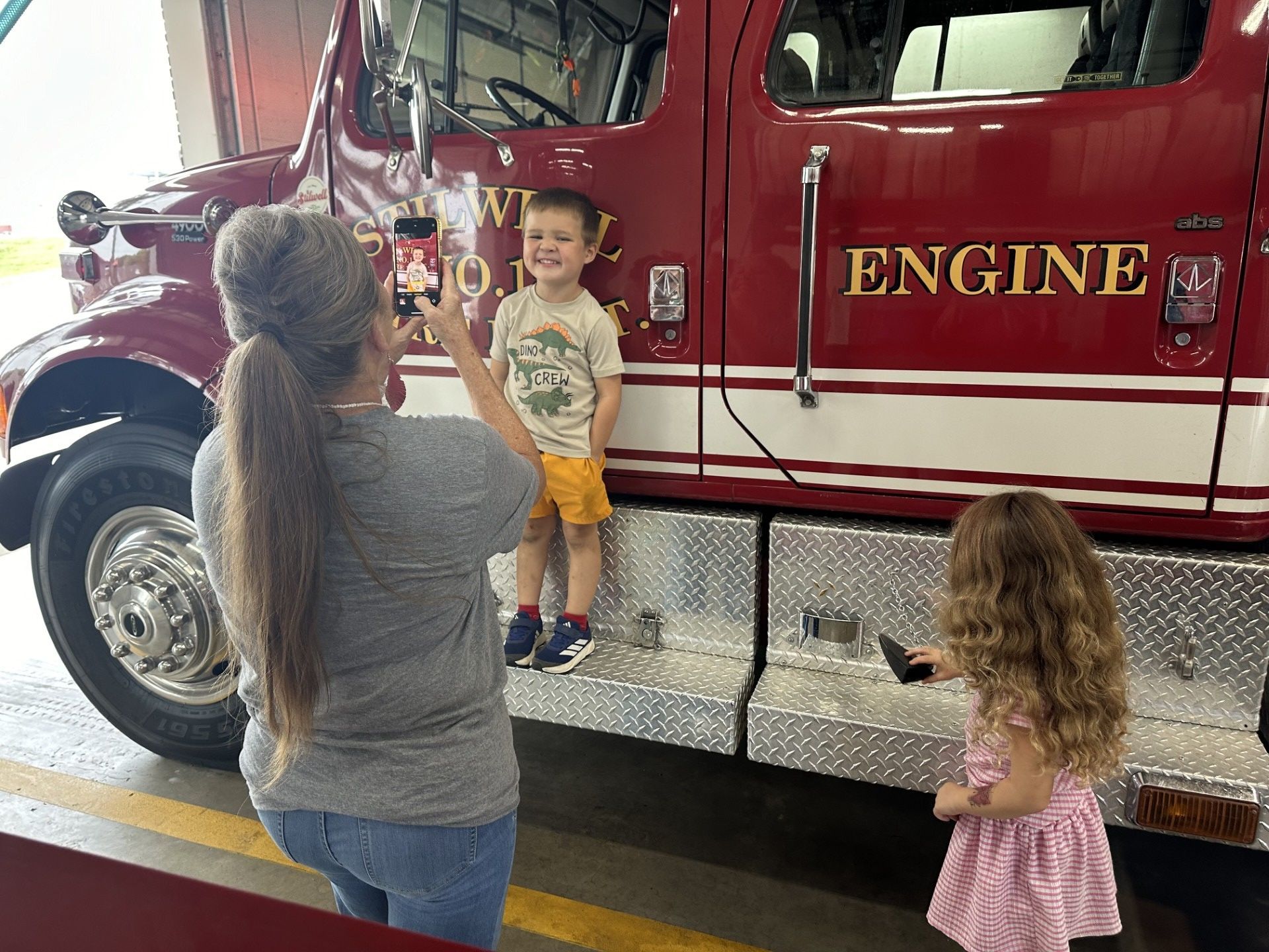 Ms. Dawson and Ms. Dawes examine a fire truck.