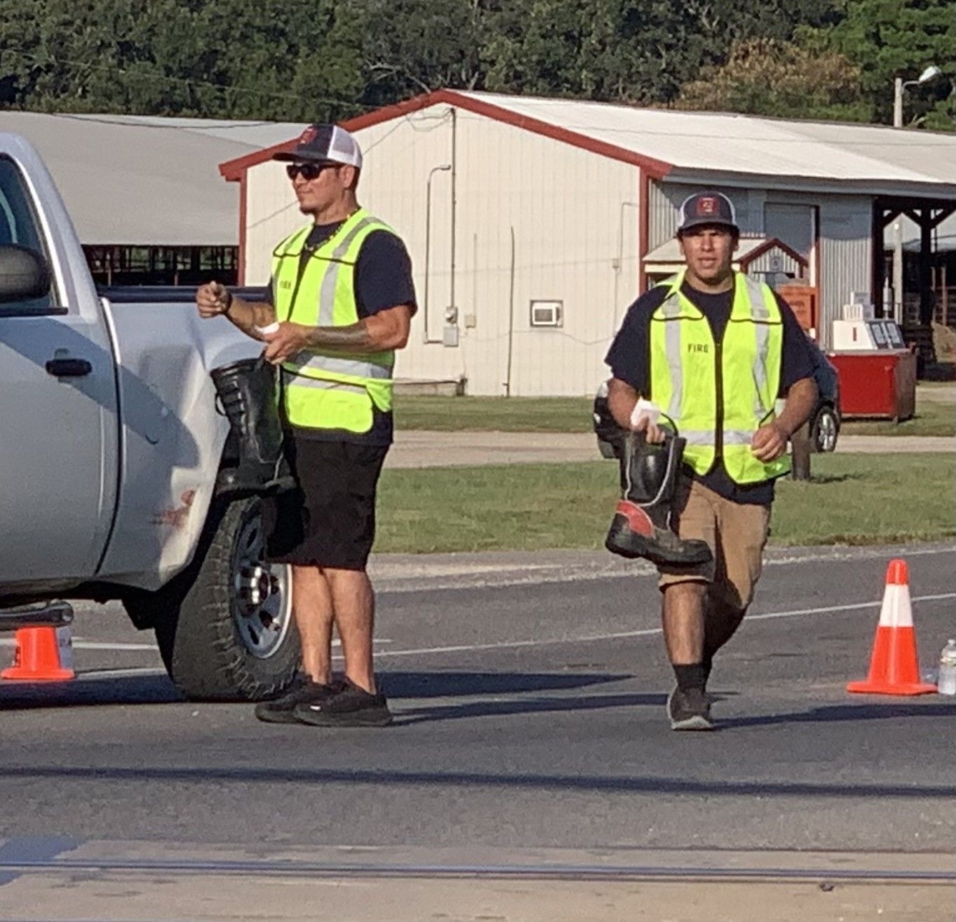 Dustin Wolfe, left, and Isaiah Castro, keep up with donations as vehicles move on. 