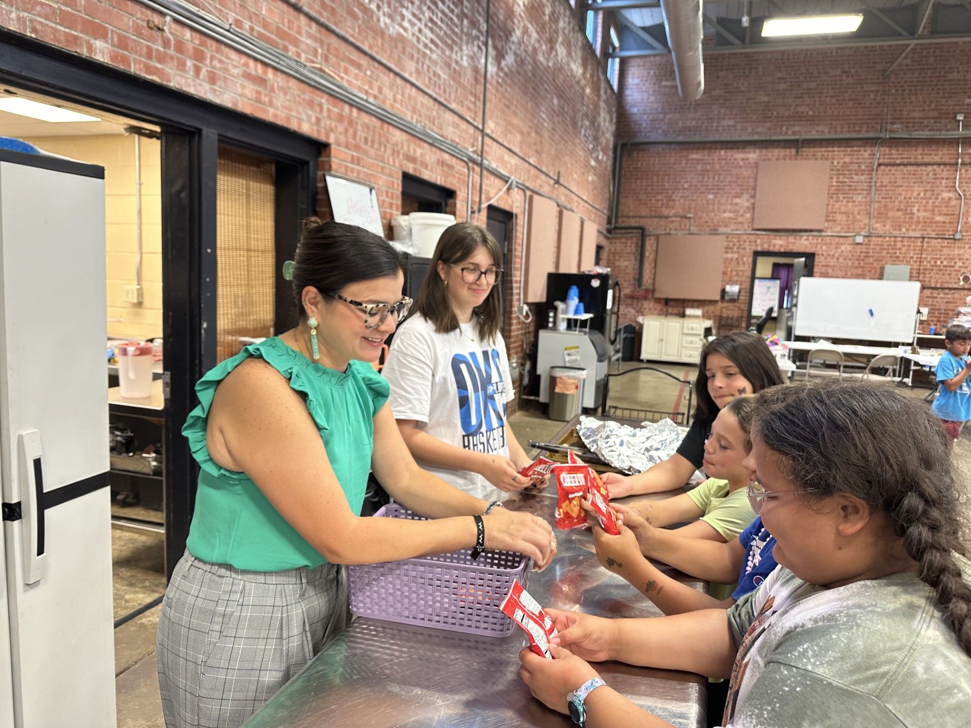 A group of people are standing around a table in a room.