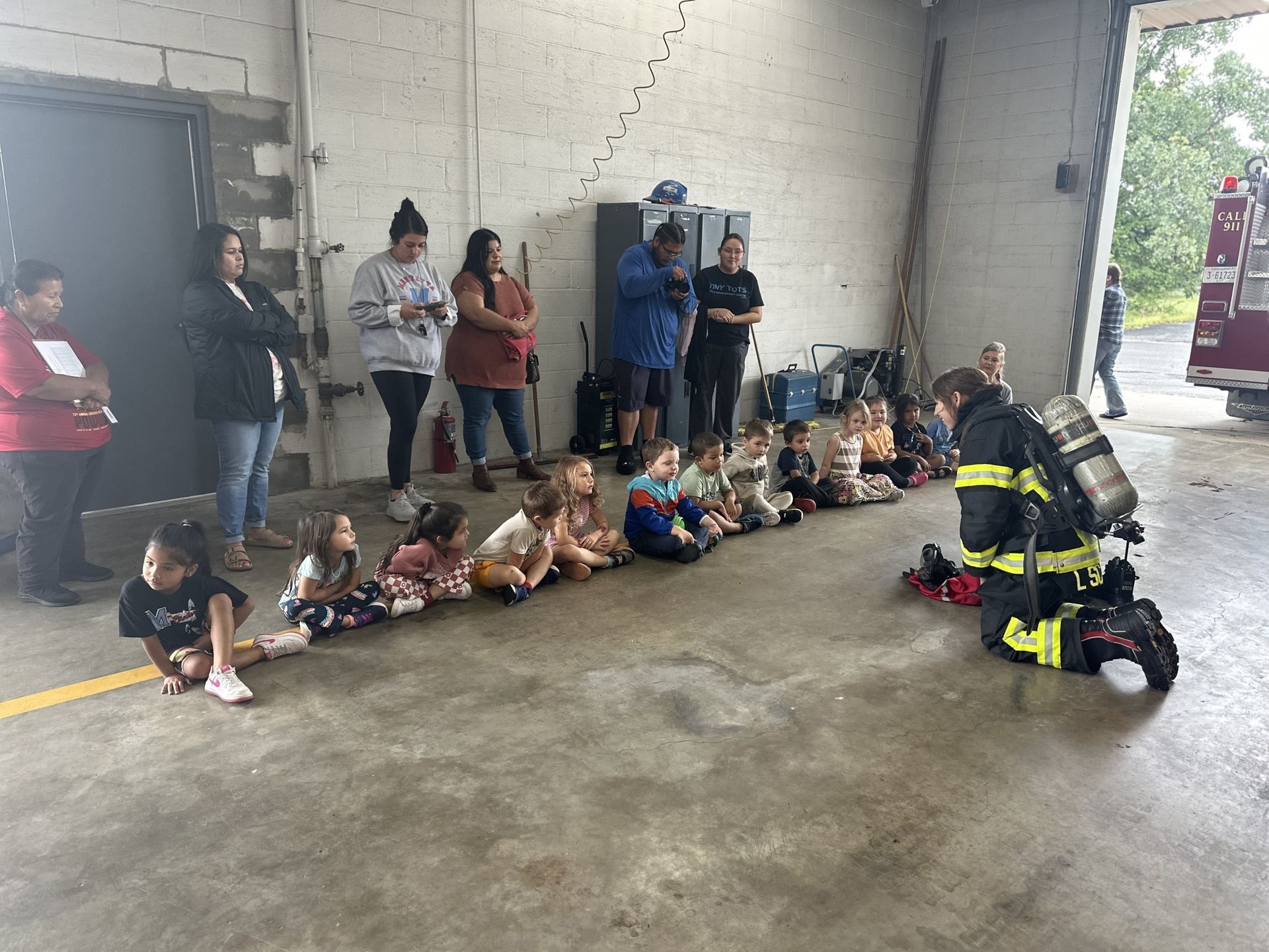 Stilwell firefighter shows Maryetta students her gear.