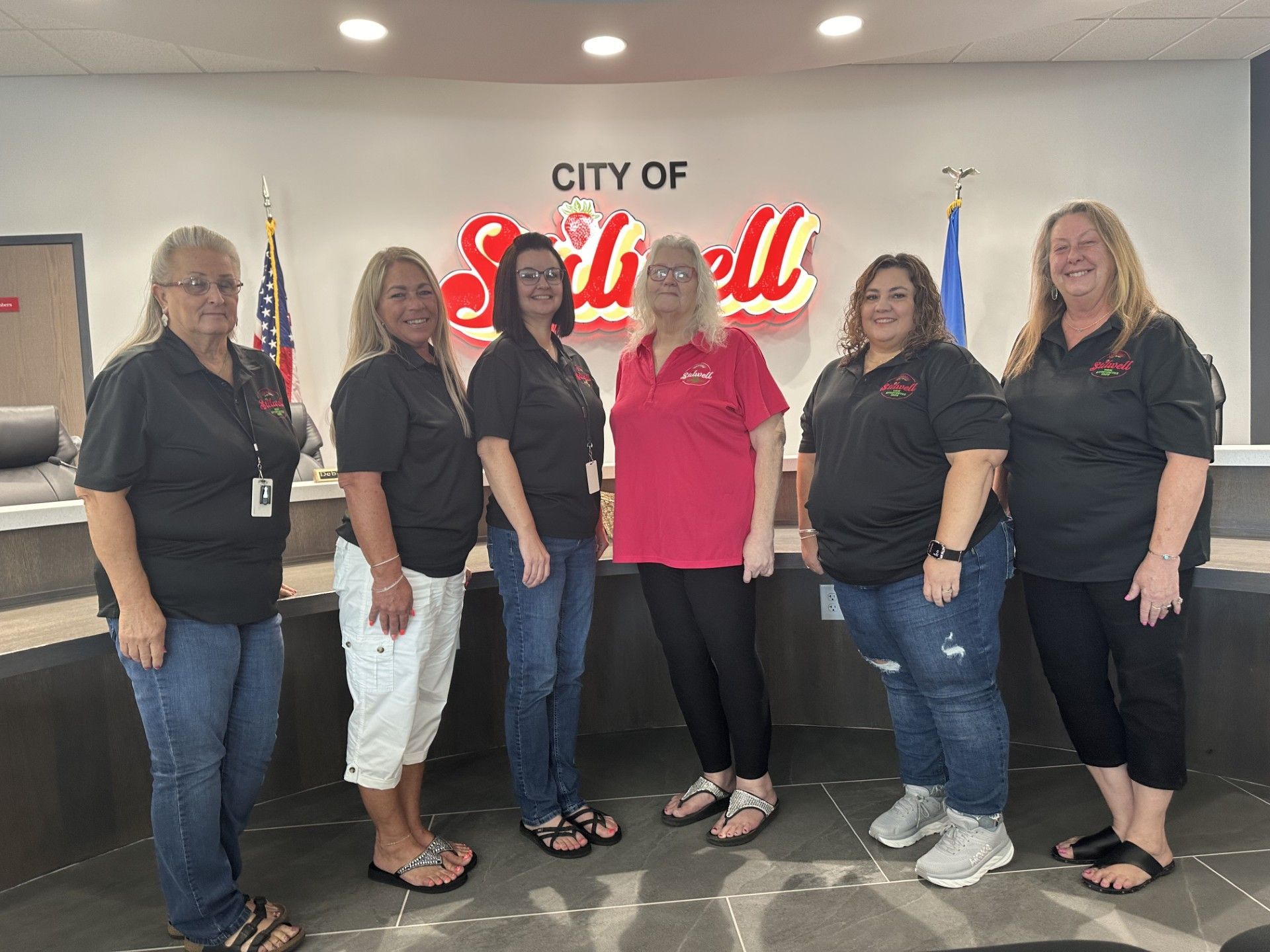 Ladies of City Hall, from left, are Denise Brown, Cindy Carson, Amy Duncan, Jean Ann Wright, Sheila Chronister and Renee Fite. standing in front of a sign that says city of Stilwell.