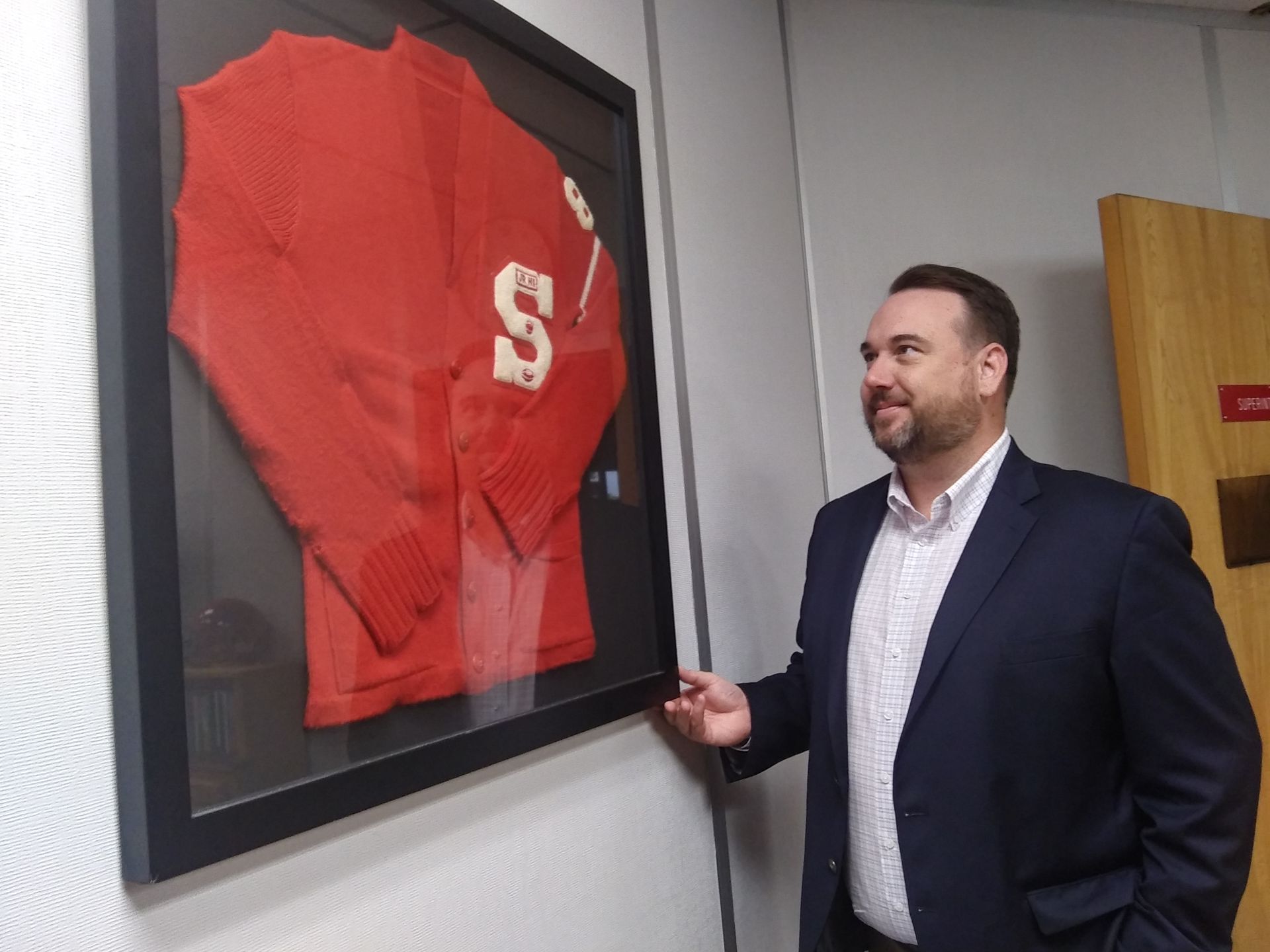 Stilwell Superintendent Matthew Brunk has his dad’s high school letter sweater framed in his office. 