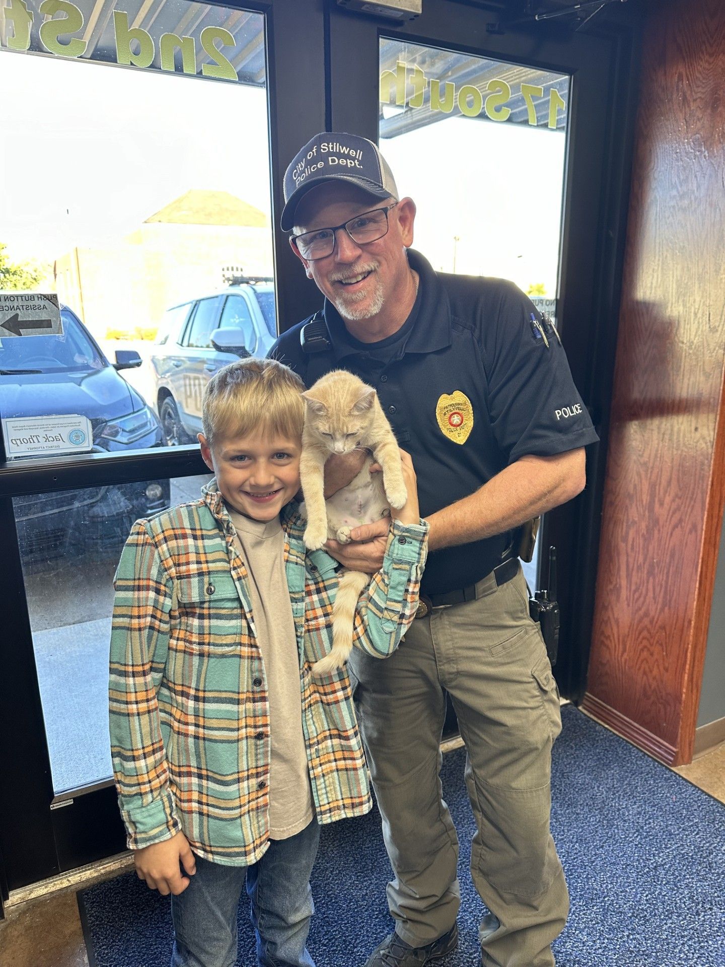 Major, the Stilwell Police Department mascot, Chief of Police Chad Smith and grandson Quinn Philpot