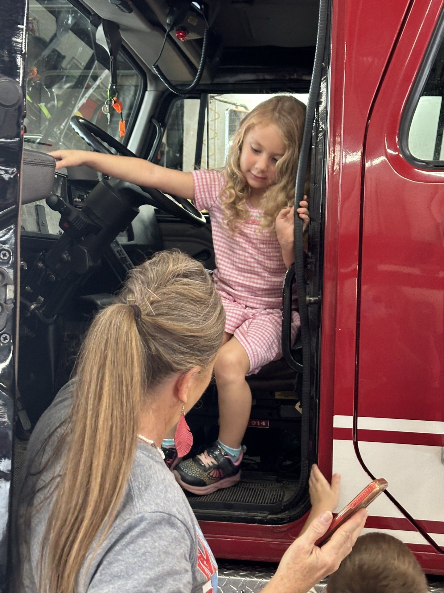 Ms. Riverland and Ms. Blackerby enjoy seeing a fire truck up close.