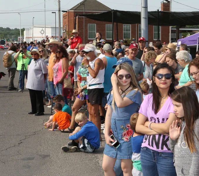 A crowd waits for the parade on 2nd Street during the Stilwell Strawberry Festival.