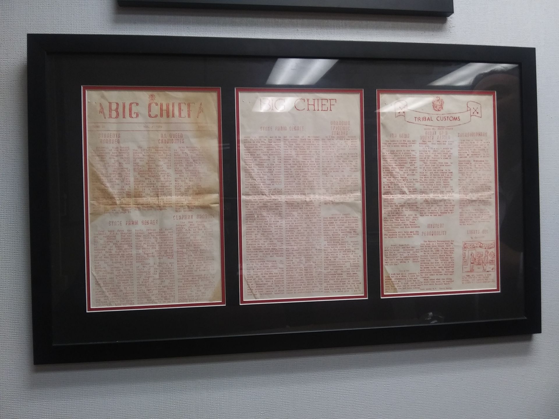 Three high school newspapers from decades past are framed and displayed in his office. 