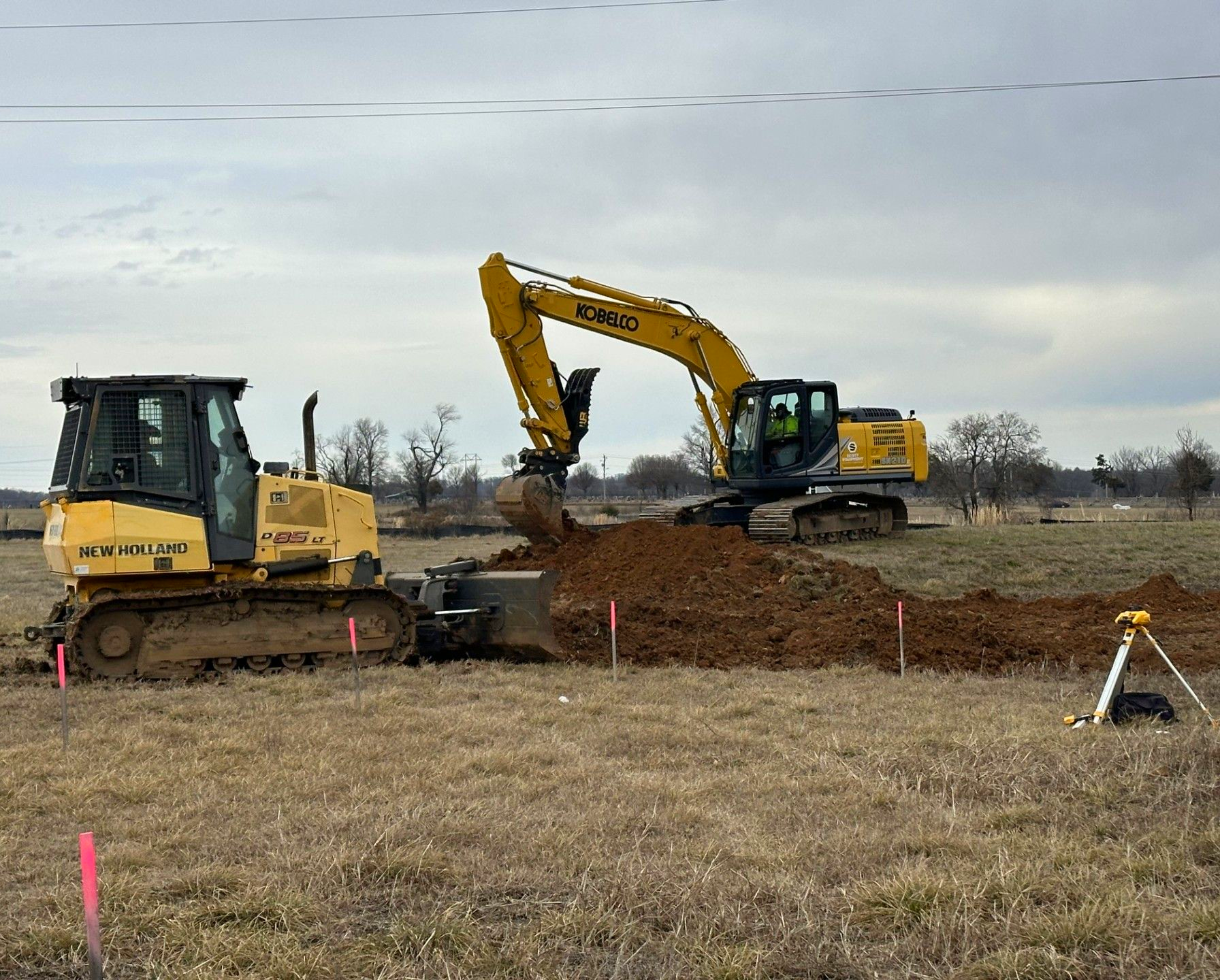 City crews work to reshape the pond.