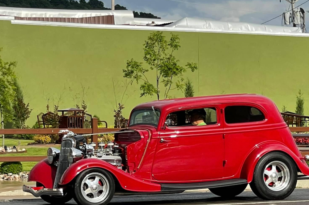 a red hot rod in front of Fletcher Park 