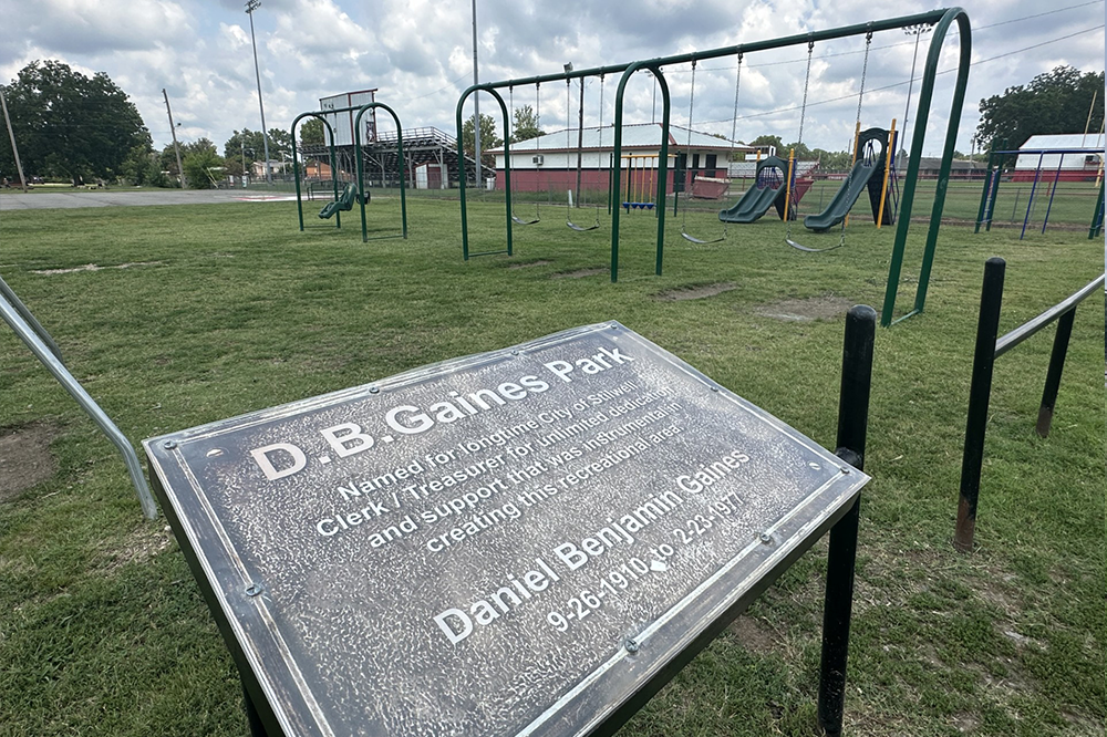 A playground with a sign that says db gaines park