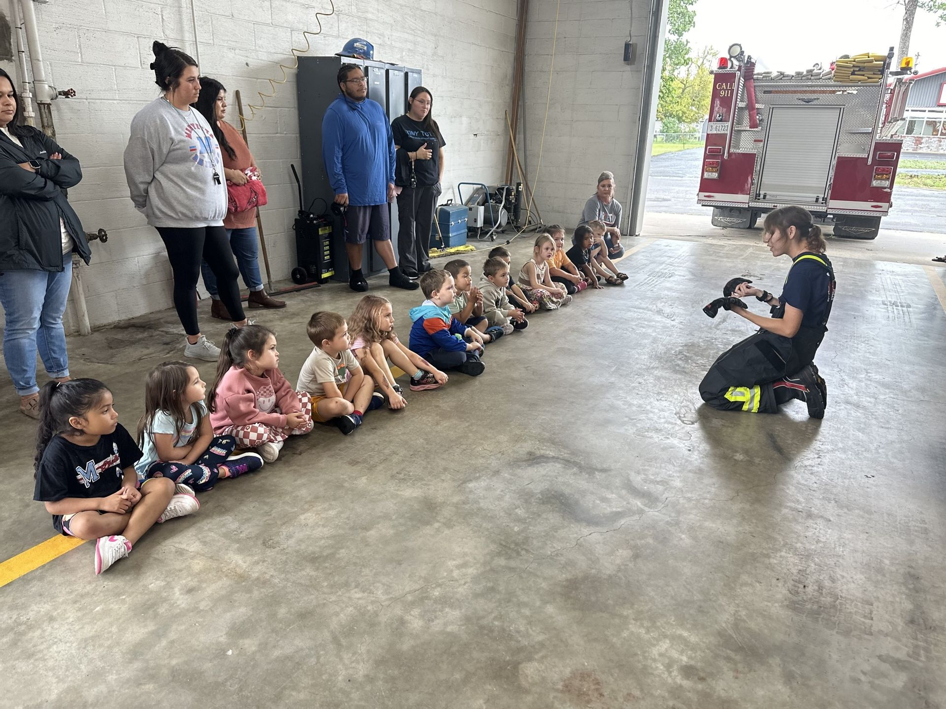 Maryetta School students listen to a firefighter explain her equipment at the Stilwell Oklahoma s