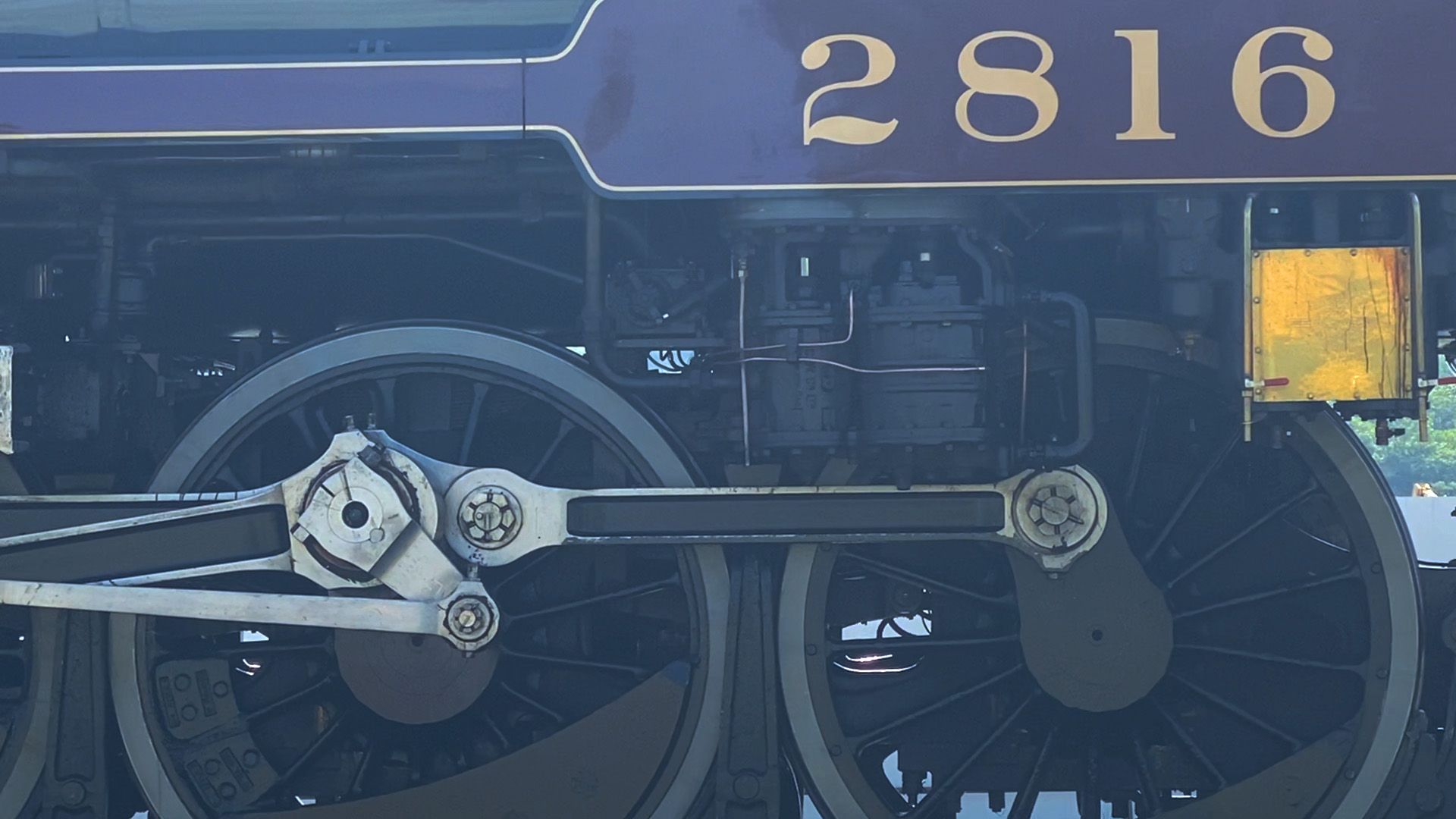 A closeup photo of train's wheel and number