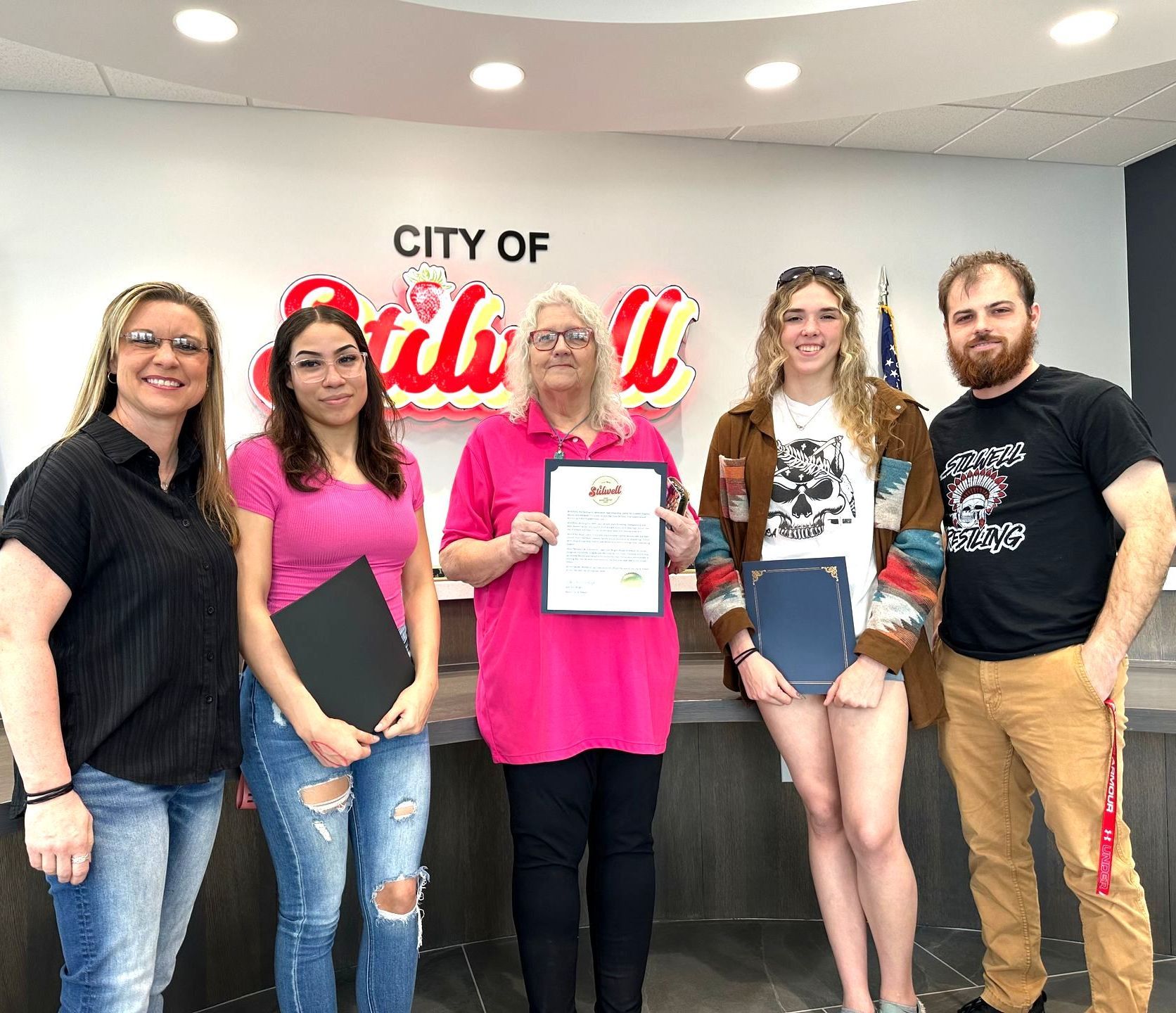 Stilwell Mayor Jean Ann Wright presents Adrianna Chronister with a certificate at city hall.