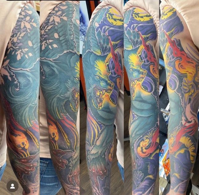 a woman has a full sleeve tattoo on her arm