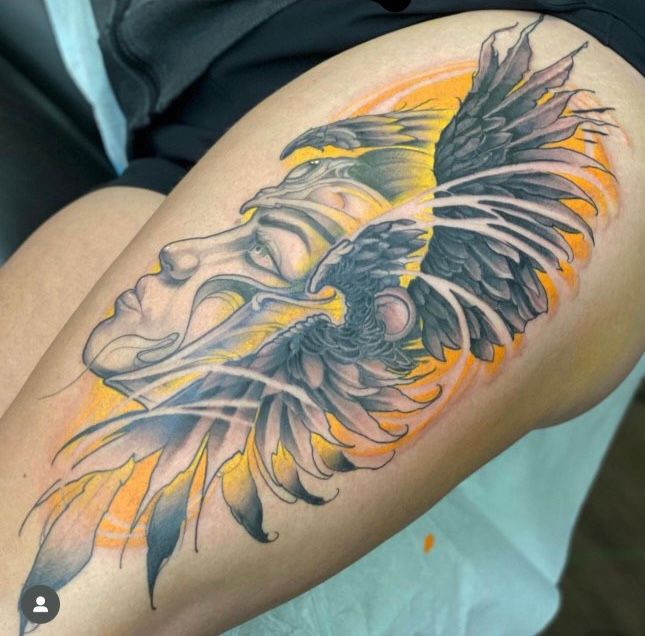 a woman has a tattoo of an eagle on her leg