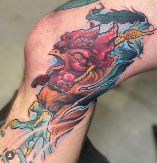 a man has a tattoo of a rooster on his leg