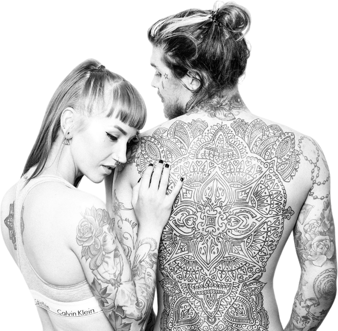 a man and a woman with tattoos on their backs are standing next to each other