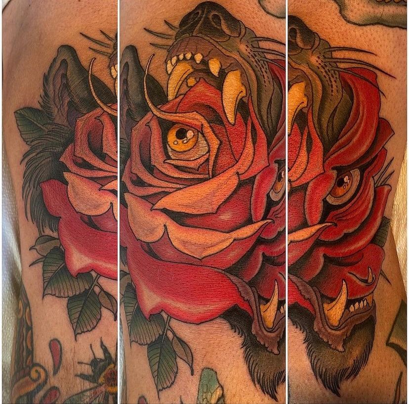 a tattoo of a tiger with a rose in its mouth