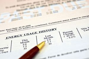 a pen is sitting on top of an energy usage history form .